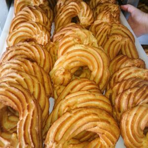 Golden brown Spanish pastries Almojábenas on a tray.