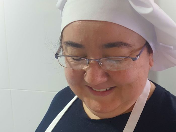 Portrait of Ana Navarro with a chef hat.