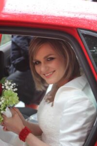 Author as bride getting out of a car.