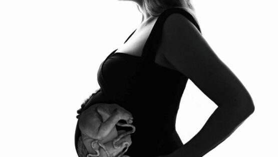 Woman with a transparent womb showing an unborn baby.