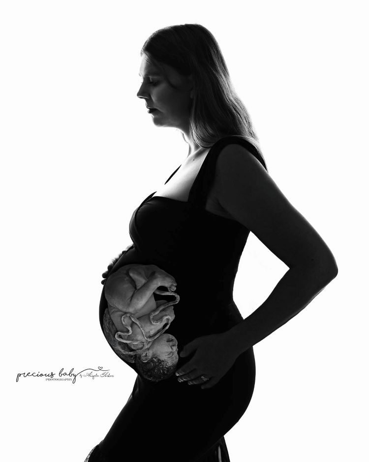 Woman with a transparent womb showing an unborn baby.