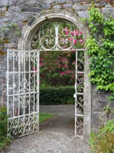 White wrought iron gate at Walled Garden, Garnish Island, West Cork.