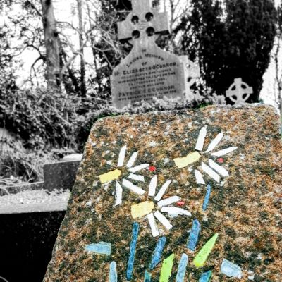 Leaning, colourful gravestone in Kilquade Cemetery, Co. Wicklow.